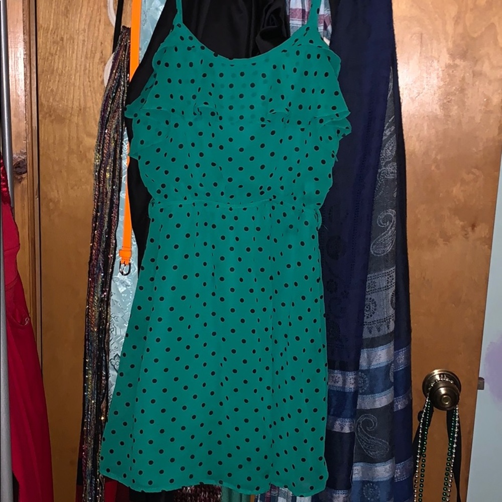 Green dress with black polka dots.